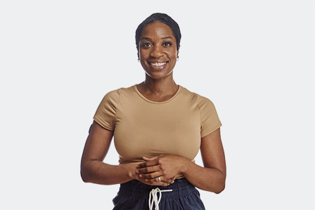 Woman flexing her arm displaying a continuous glucose monitor with Eversense’s affordable CGM cost.  